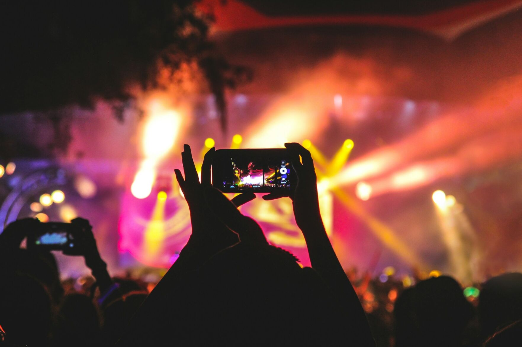 Person record a music and light show at a high-end event